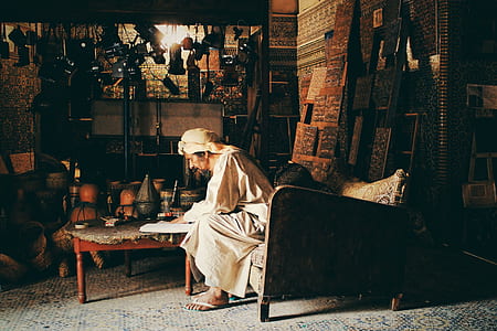 man in white robe dress sitting on chair thumbnail