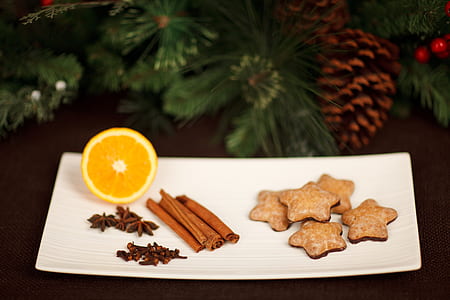 cinnamon stick beside sliced orange thumbnail