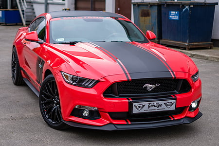 red and black Ford Mustang coupe on concrete road thumbnail
