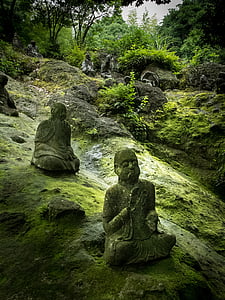 three Buddha figurines on rock thumbnail