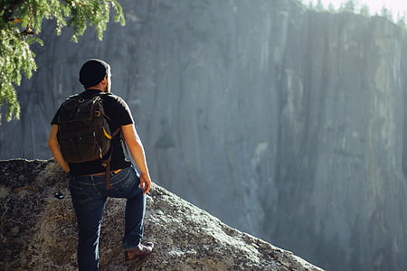 man standing on cliff at daytime thumbnail