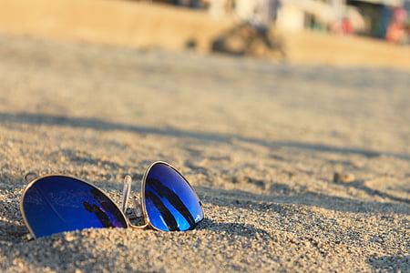 blue aviator sunglasses on brown sands thumbnail
