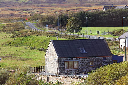 black and gray house on green grass field thumbnail