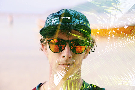 man with sunglasses and blue Hurley cap thumbnail