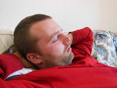 man lying while holding his nape thumbnail