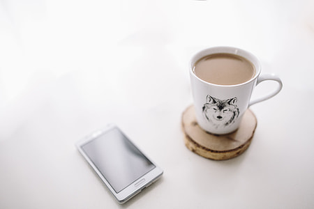 Black-and-white notebook and a white smartphone with various items thumbnail
