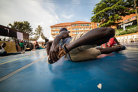 man stretching leg on floor thumbnail