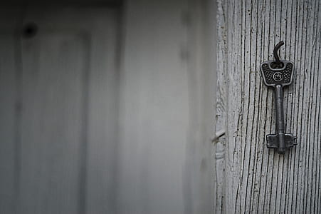 close-up photography of gray metal key on hook thumbnail