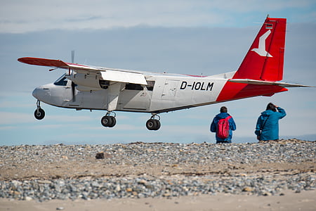 two people standing near plane flying on midair thumbnail