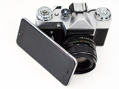 gray Zenit-E camera beside black smartphone thumbnail