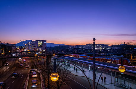 People Walking on Train Station Near Highway in Distant of Buildings thumbnail