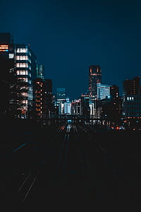 aerial view of train rails between tall buildings thumbnail