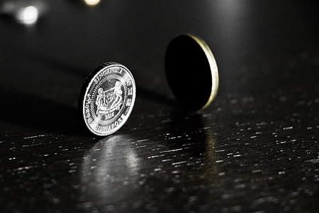 two standing silver-colored and gold-colored coin thumbnail