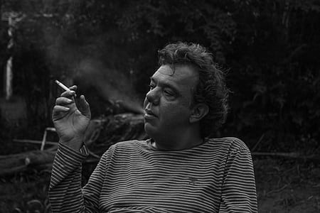 man holding cigarette stick thumbnail