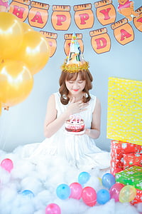 woman holding cake with 20 years candle thumbnail