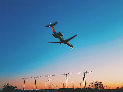 black airplane flying on air under blue sky thumbnail