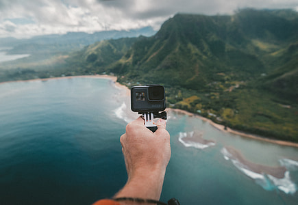 person holding black sports camera during daytime thumbnail