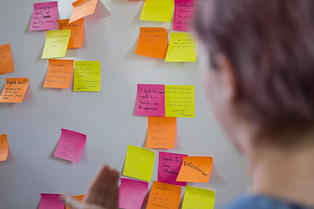 assorted-color sticky notes on white wall thumbnail