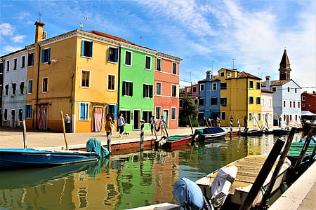 assorted colored concrete 3-storey houses under calm blue sky thumbnail