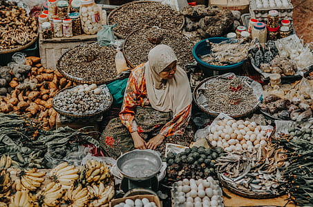 woman surrounded by variety of fruits thumbnail