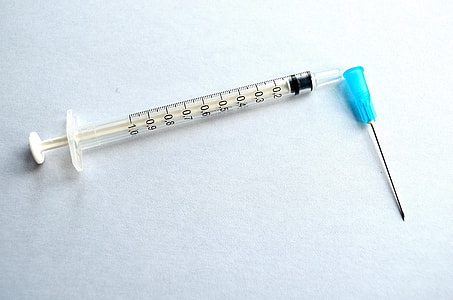 white syringe on white surface thumbnail