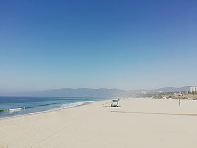 calm beach under blue sky thumbnail