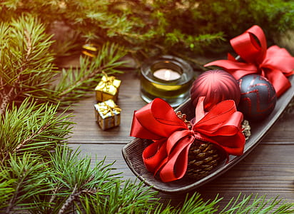 red and black baubles beside conifercone thumbnail