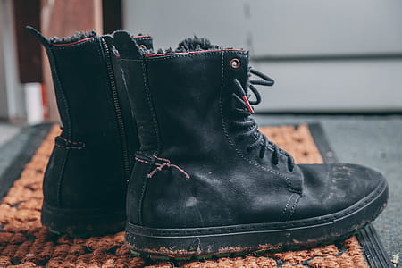 Pair of Black Lace-up Boots on Area Rug thumbnail