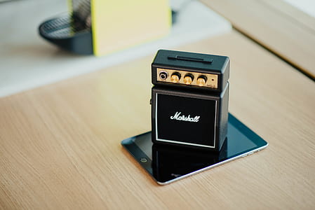 black Marshall miniature guitar amplifier on black iPad turned off thumbnail
