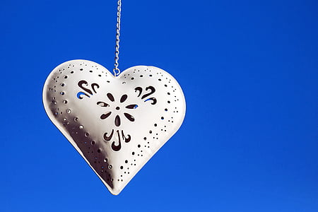 silver-colored heart pendant with chain necklace and blue background thumbnail