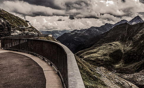 Gray Metal Railings on Top of Hill Under Gray Cloudy Sky at Daytime thumbnail