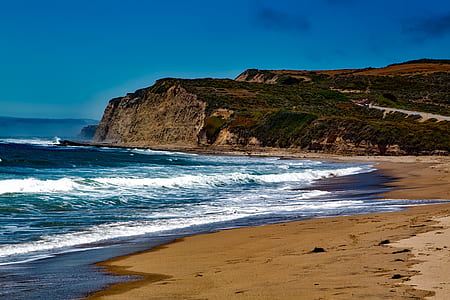 photography of sea and mountain at daytime thumbnail