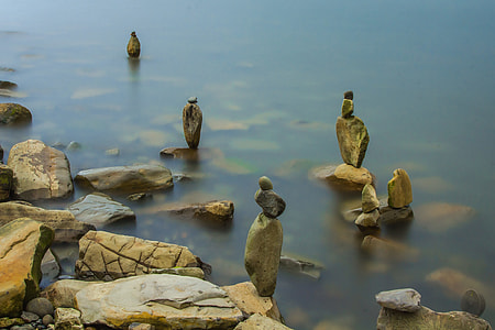 standing rocks on body of water at daytime thumbnail