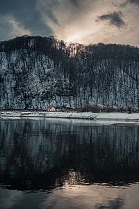 mountain reflecting on body of water thumbnail