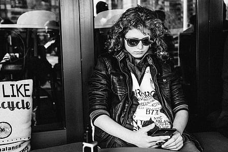 person in black zip-up jacket using black smartphone thumbnail