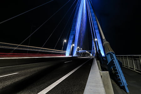 gray cable-wire bridge during nighttime thumbnail