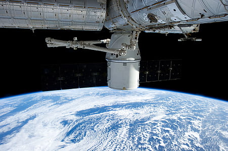 white satellite orbiting earth thumbnail
