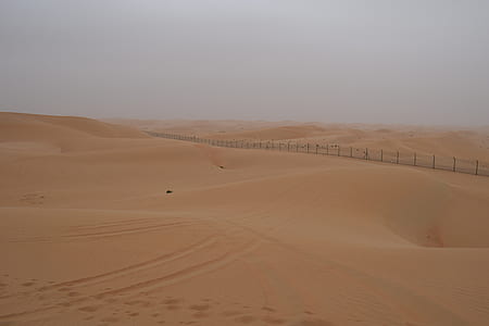 calm desert under gray sky thumbnail