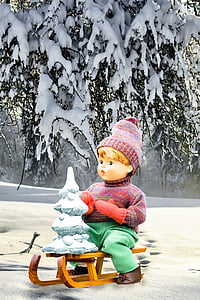 boy doll riding sleigh thumbnail