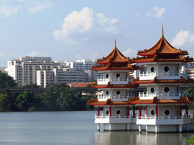 two white-and-brown temples on body of water at daytime thumbnail