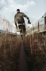 man facing backwards while walking thumbnail