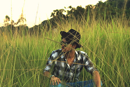Man Sitting on Green Grass Field thumbnail