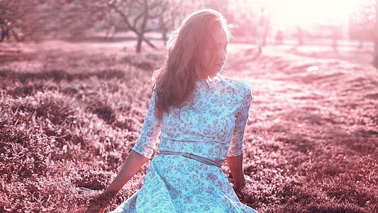 woman wearing white dress sitting on grass thumbnail