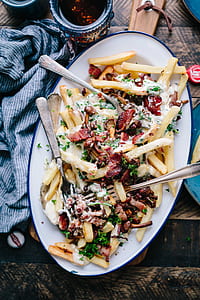 fries topped with cream and vegetable thumbnail