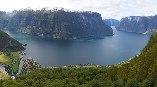 green mountain near body of water thumbnail