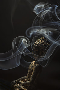 Gautama Buddha figurine surrounded with smoke thumbnail