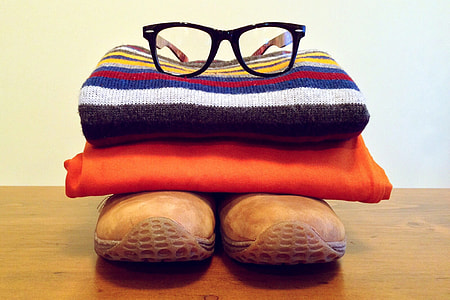 Clothes and reading glasses in pile thumbnail