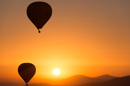 two hot-air balloons silhouette during golden hour thumbnail