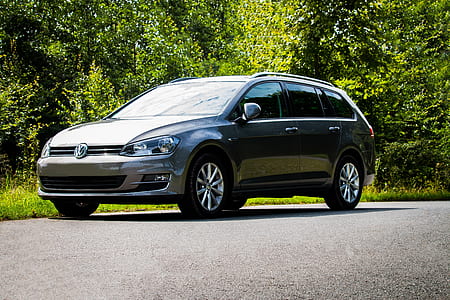 gray Volkswagen Golf station wagon on road near trees at daytime thumbnail
