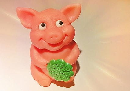 close-up photo of pink ceramic pig figurine on white surface thumbnail